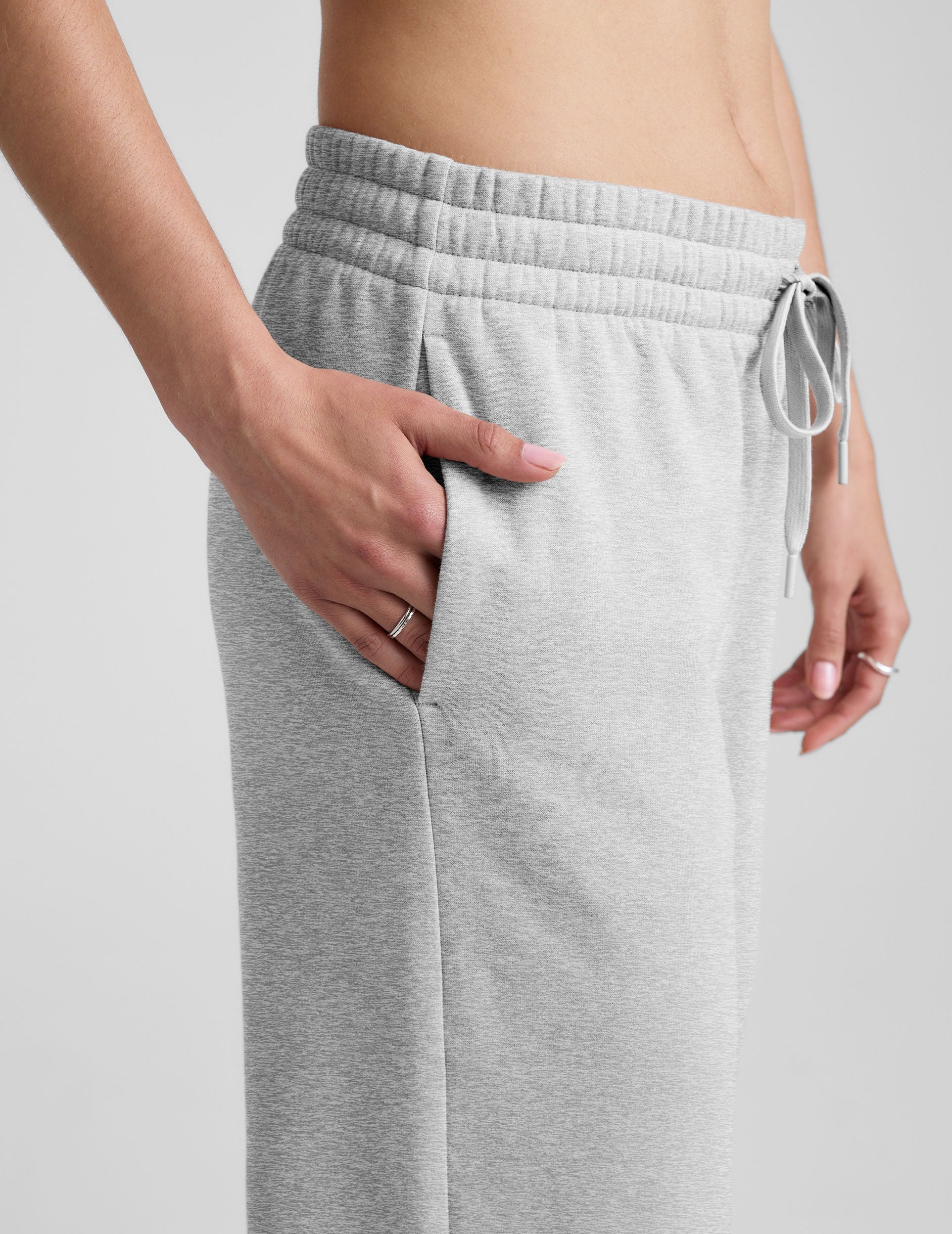 grey mid-rise wide leg sweatpants with side slits and a drawcord at waistband.