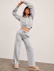 grey mid-rise wide leg sweatpants with side slits and a drawcord at waistband.