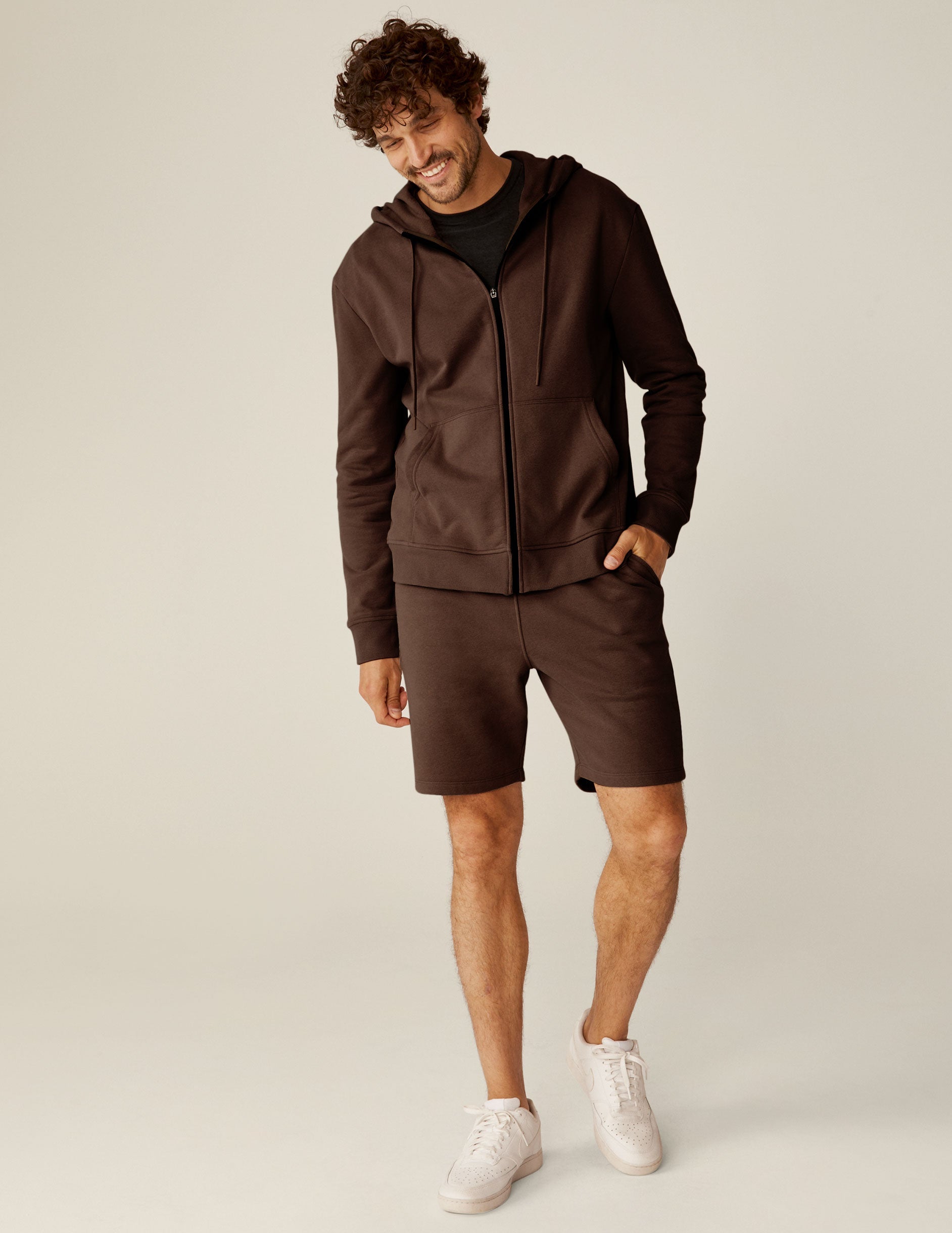 brown zip-up jacket with pockets and a hood.