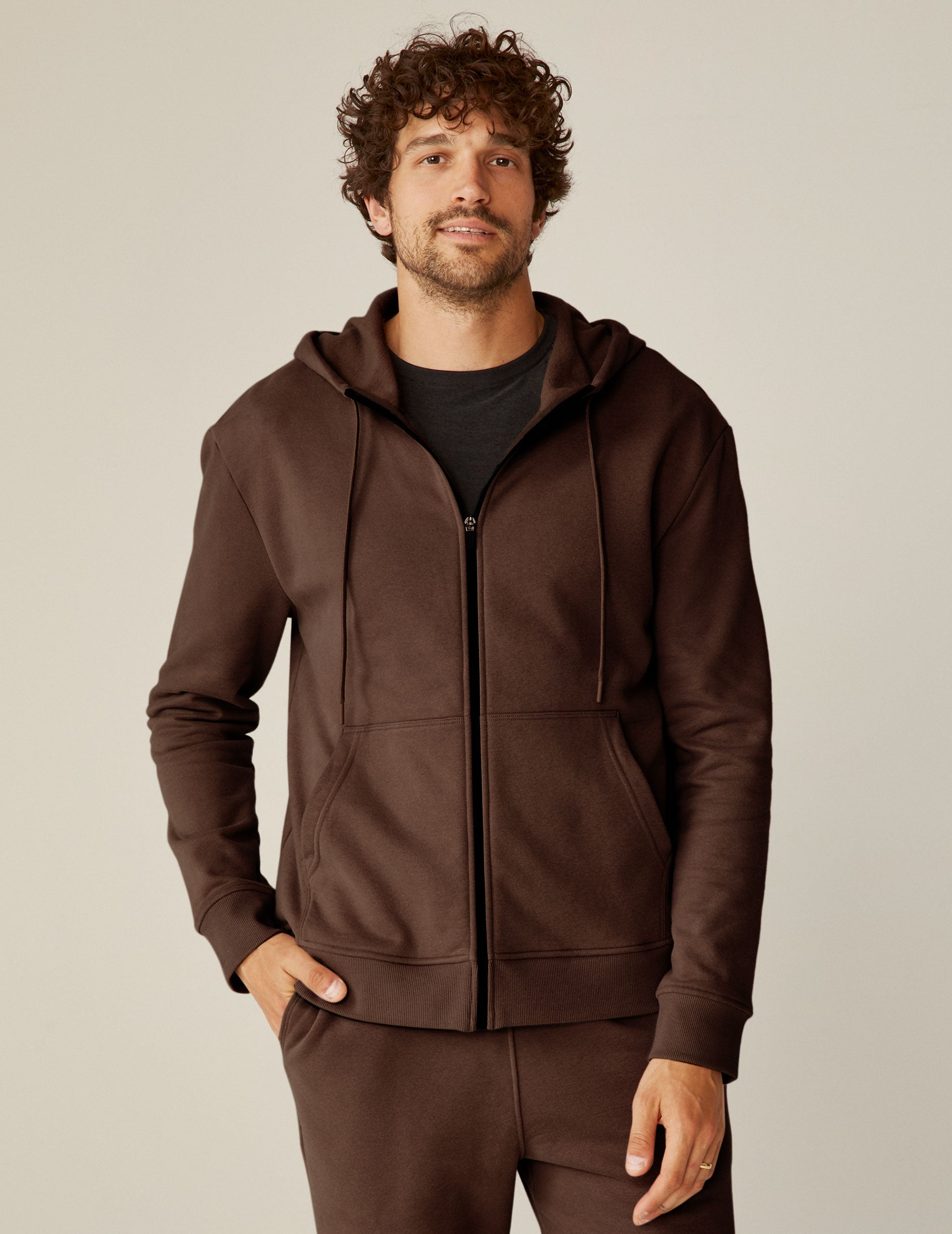 brown zip-up jacket with pockets and a hood.