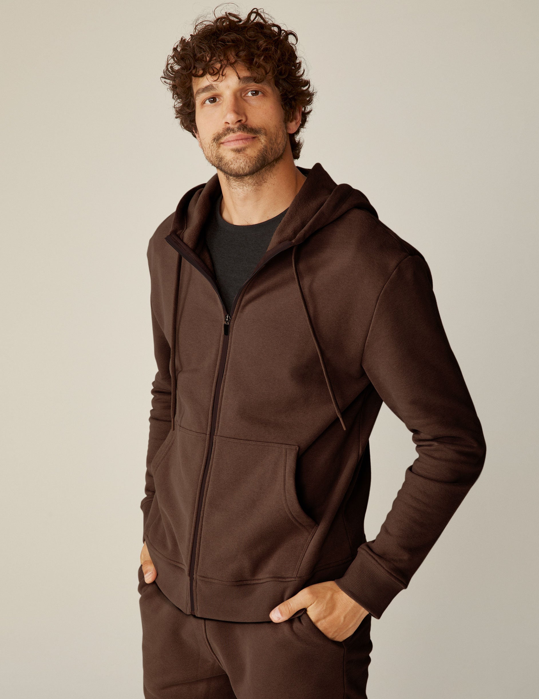 brown zip-up jacket with pockets and a hood.