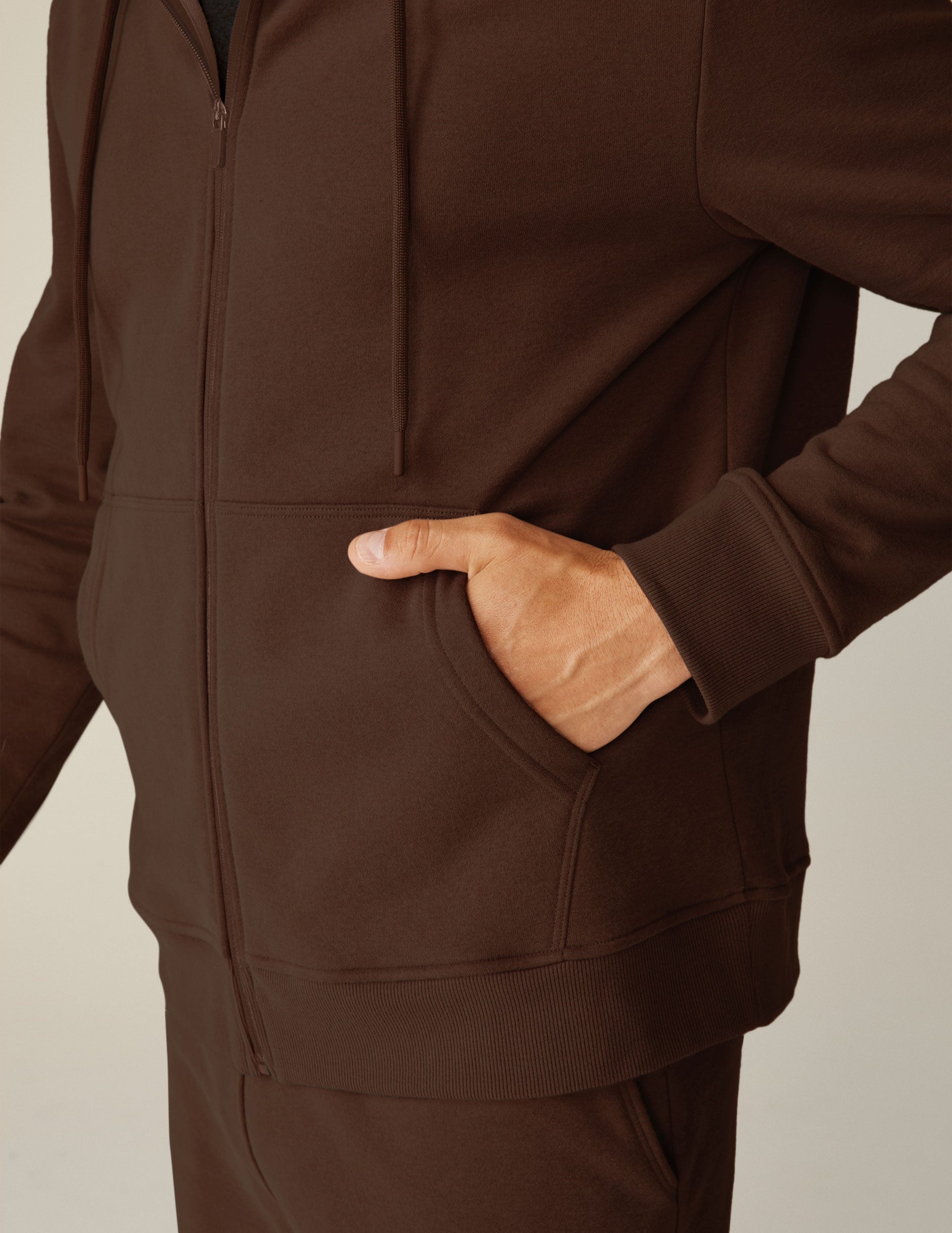brown zip-up jacket with pockets and a hood.