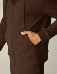 brown zip-up jacket with pockets and a hood.