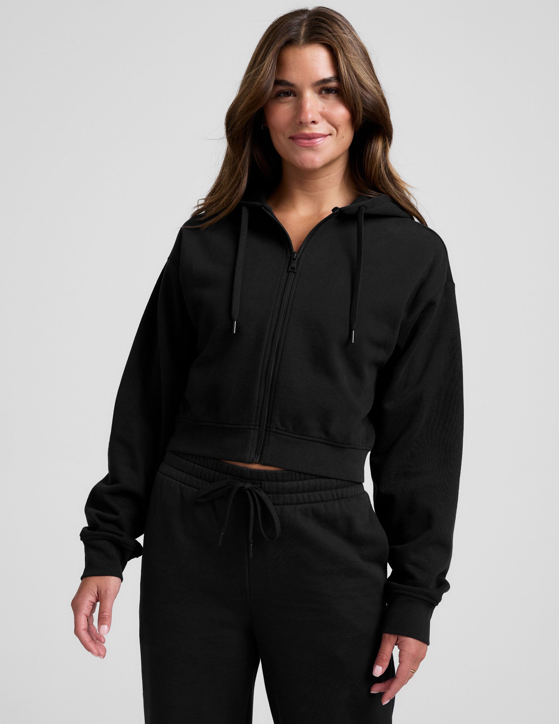 black fleece zip-up jacket with a drawstring hood.