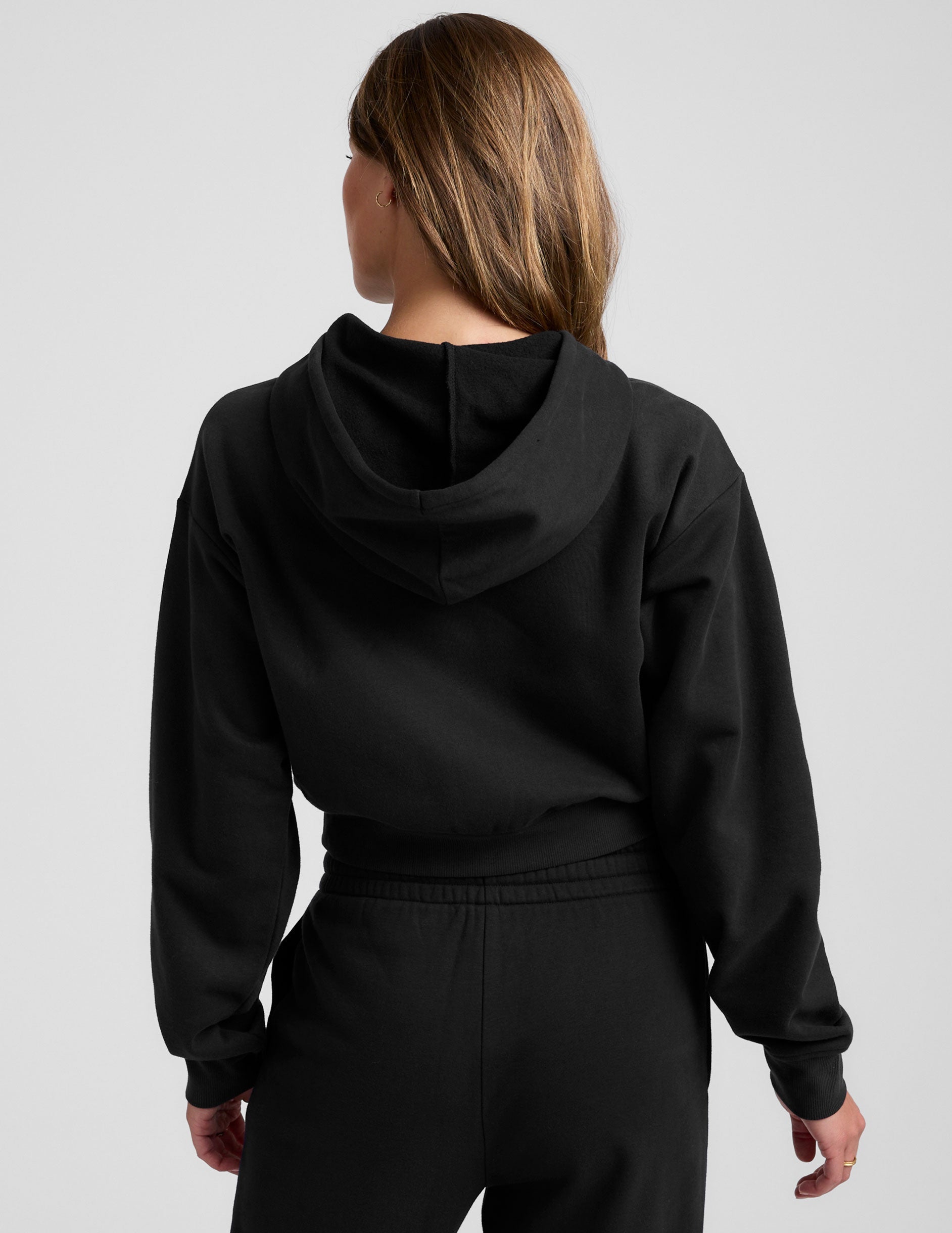black fleece zip-up jacket with a drawstring hood.