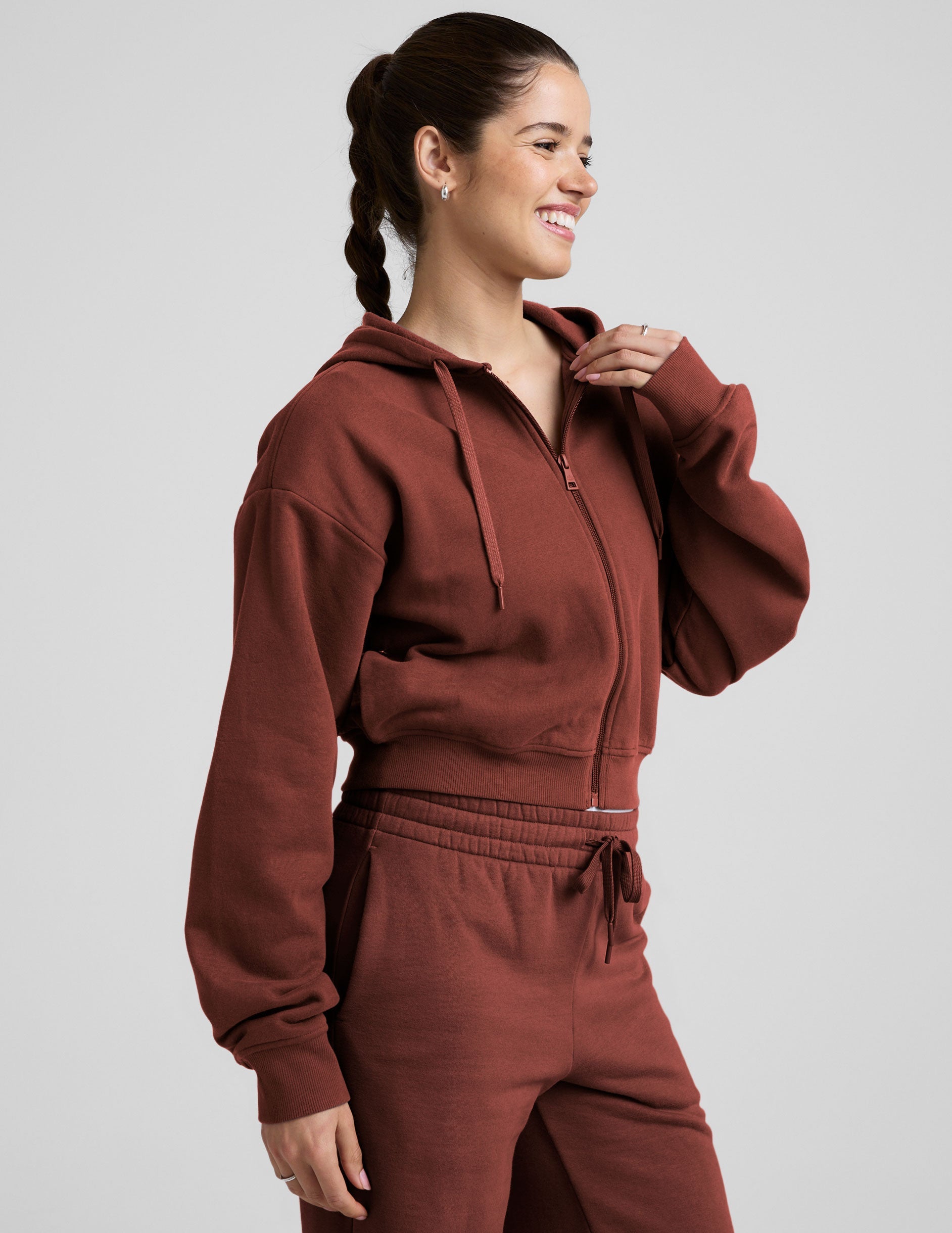 brown fleece zip-up jacket with a drawstring hood.