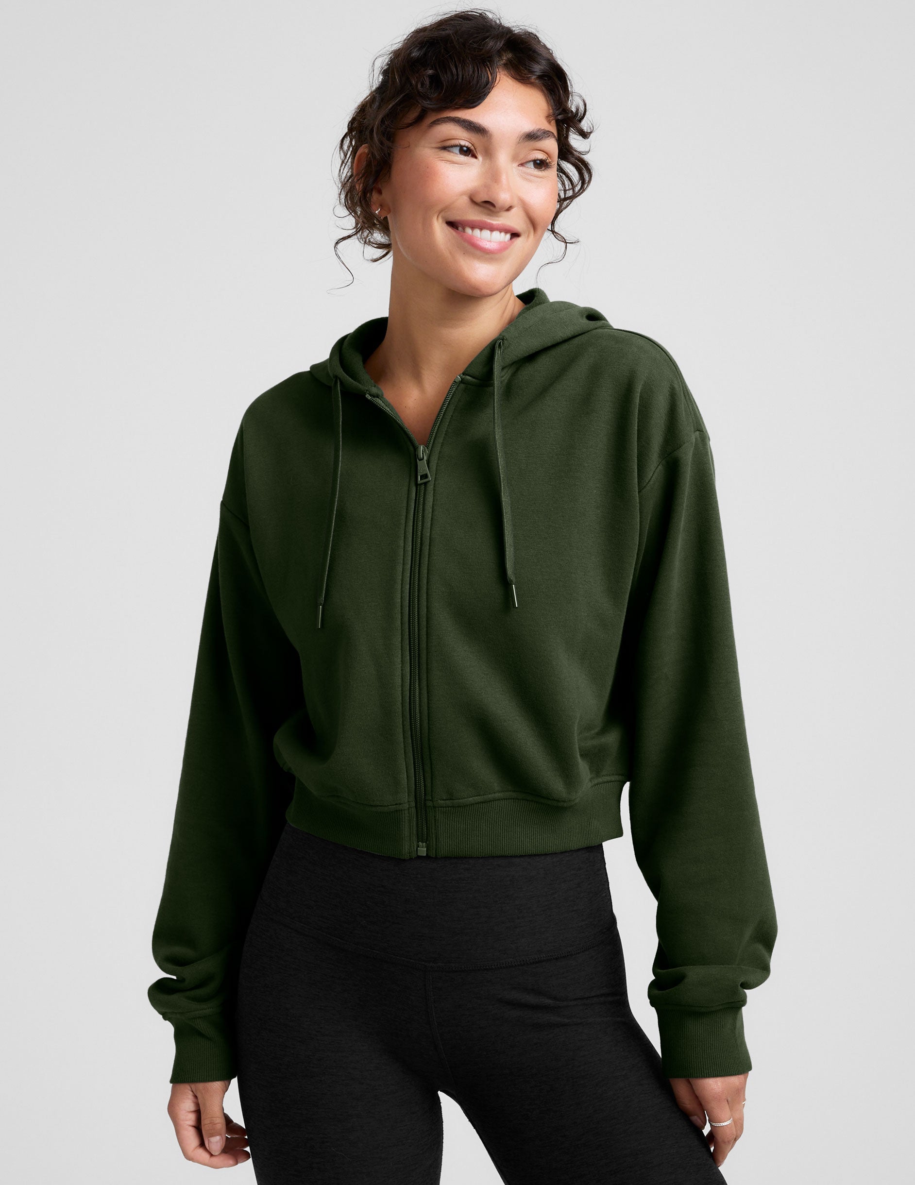 green fleece zip-up jacket with a drawstring hood.