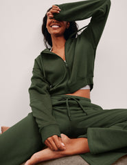 green fleece zip-up jacket with a drawstring hood.