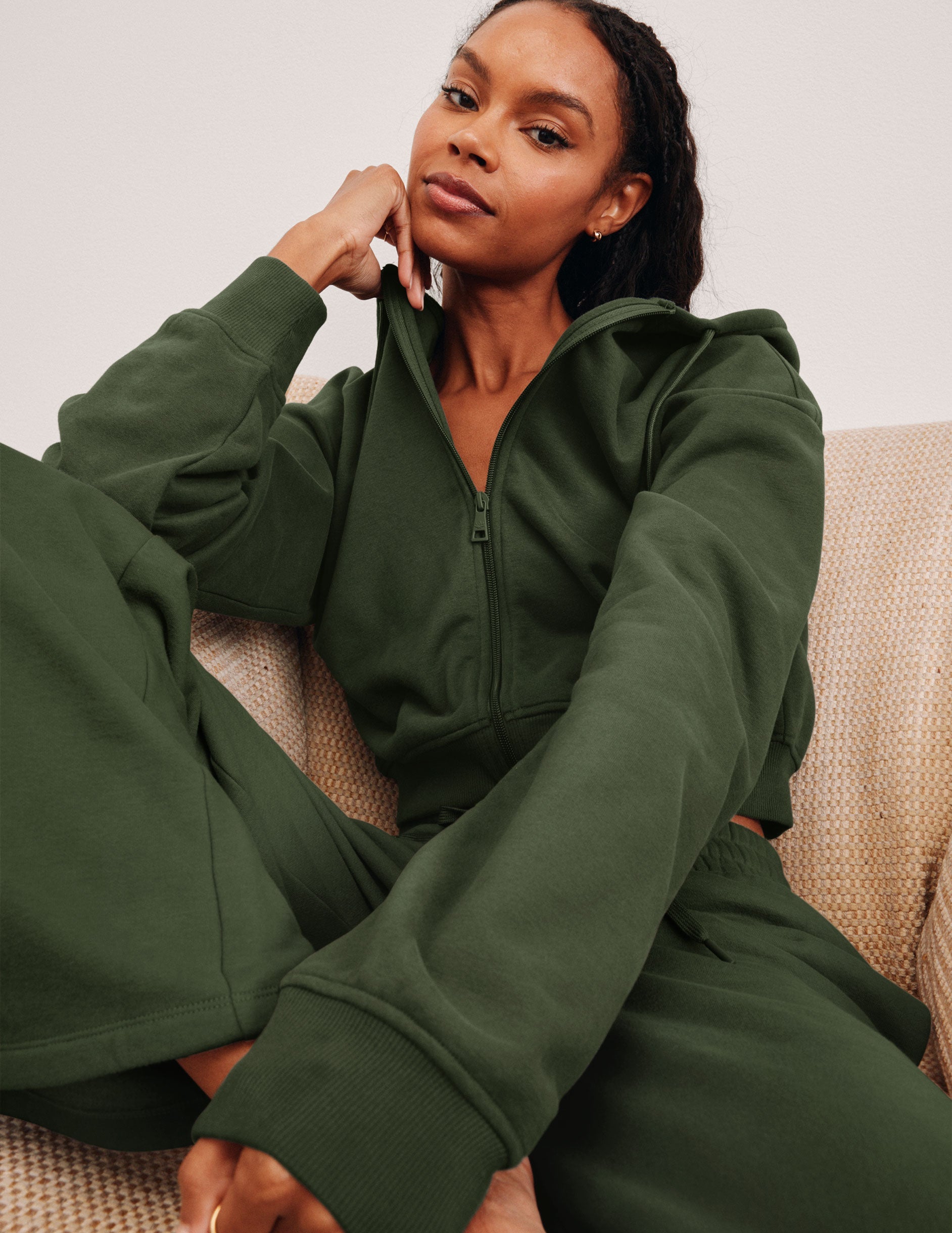 green fleece zip-up jacket with a drawstring hood.