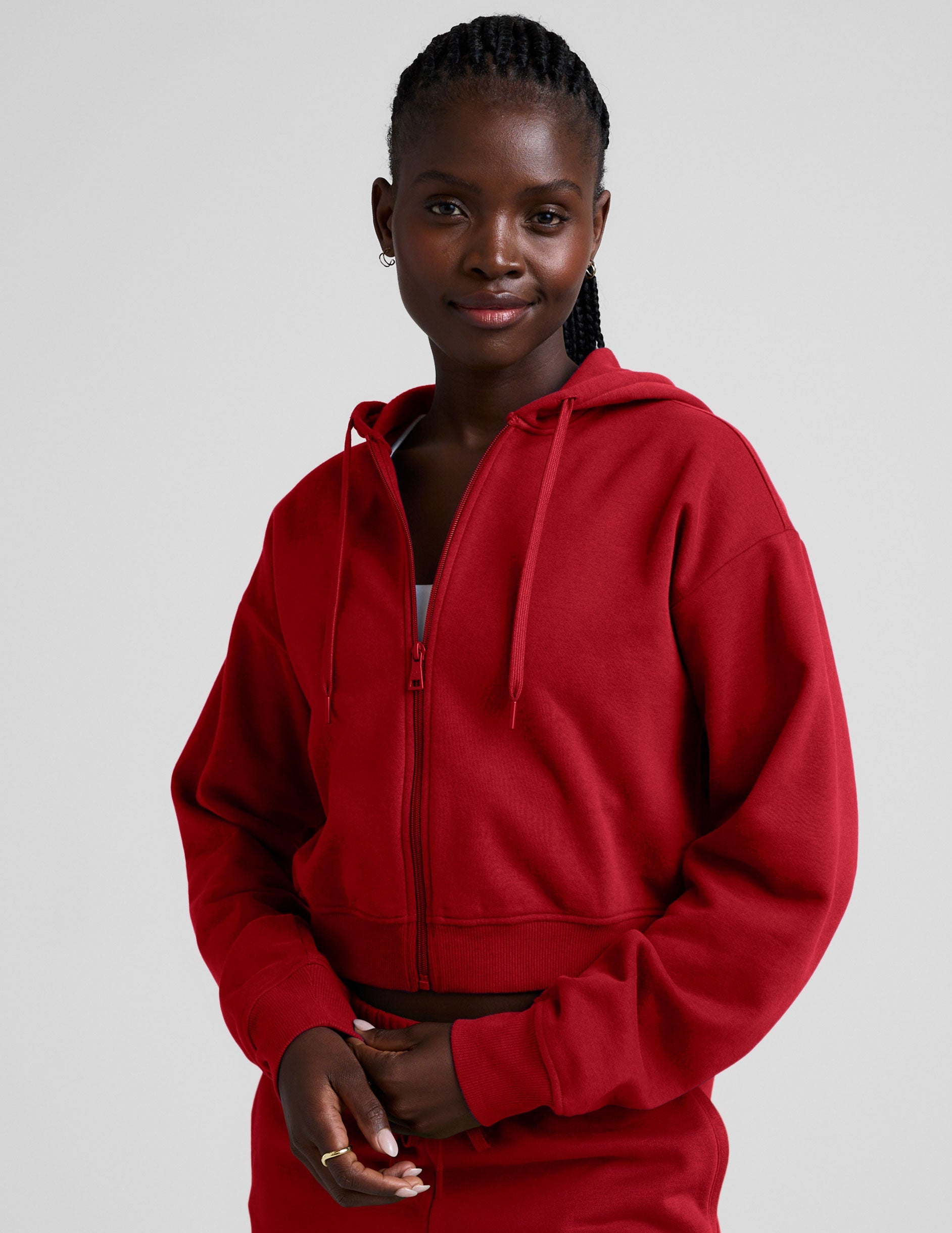 red fleece zip-up jacket with a drawstring hood.