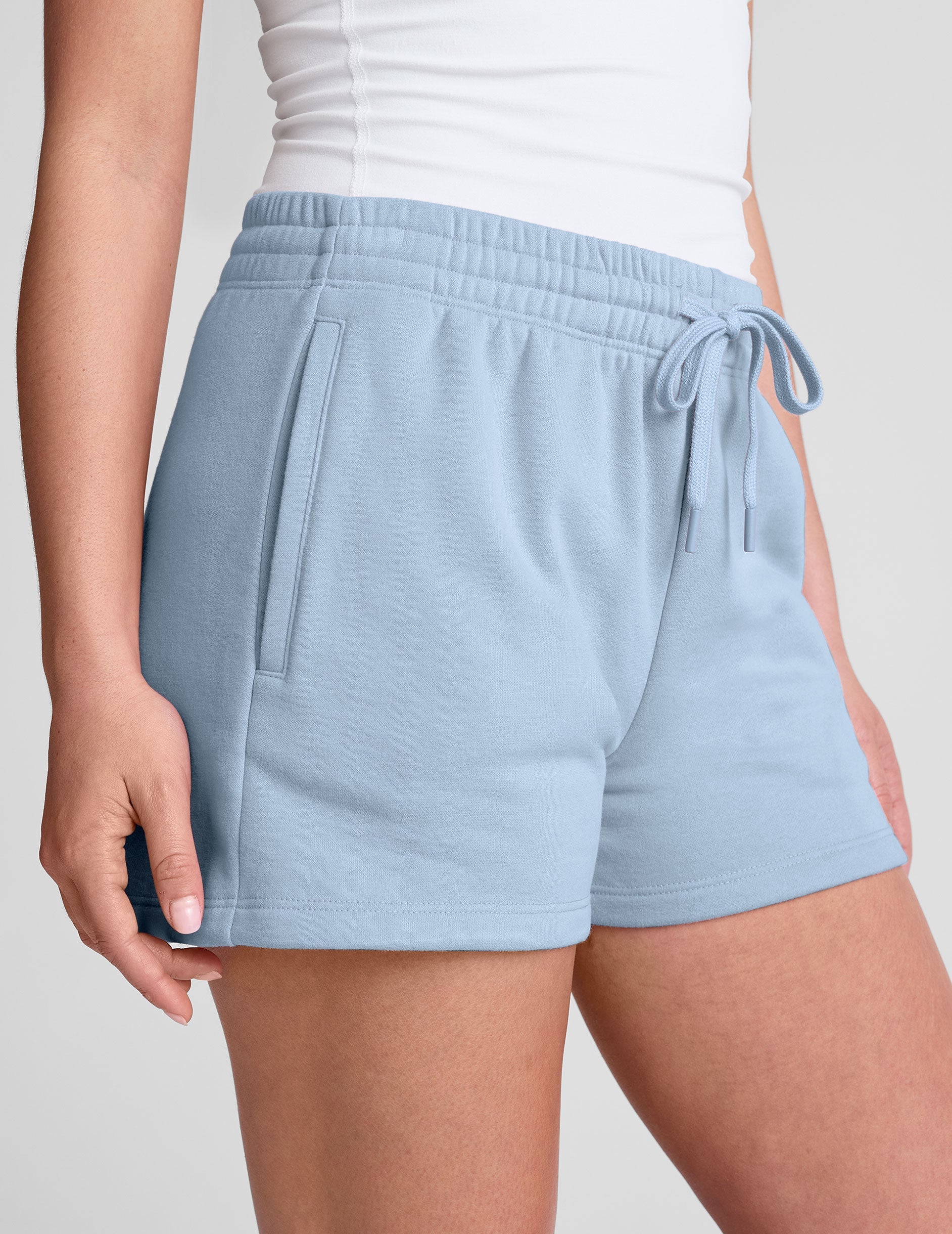 blue mid rise sweat shorts with a 3.5" inseam and pockets. 