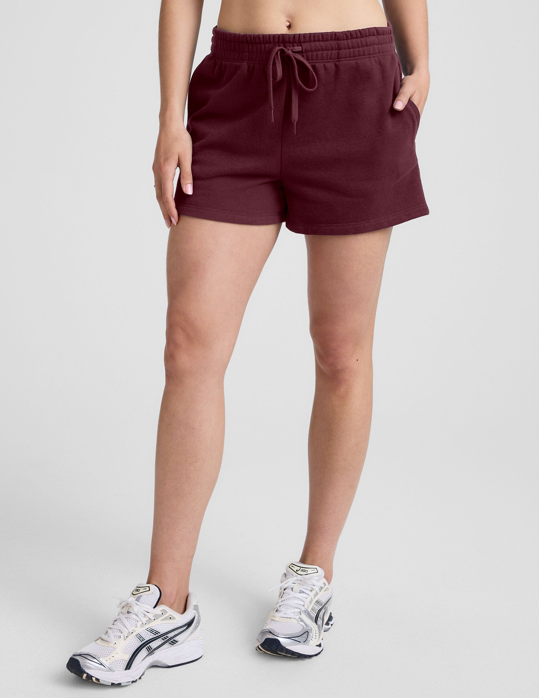 red mid rise sweat shorts with a 3.5" inseam and pockets. 