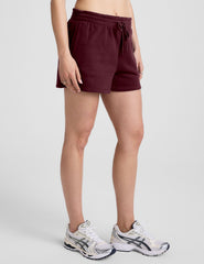 red mid rise sweat shorts with a 3.5" inseam and pockets. 