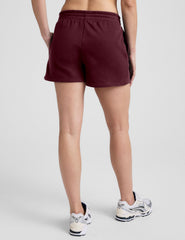 red mid rise sweat shorts with a 3.5" inseam and pockets. 