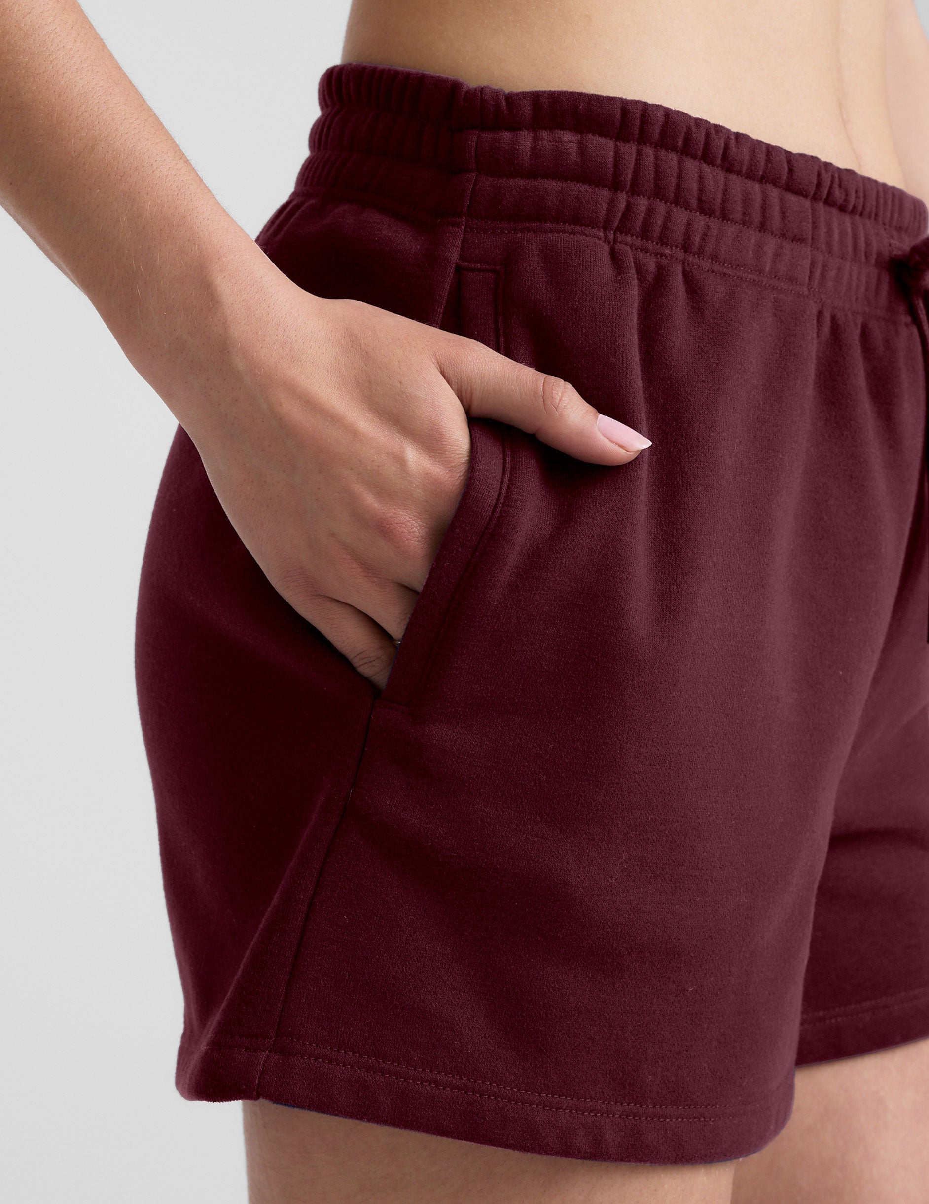 red mid rise sweat shorts with a 3.5" inseam and pockets. 