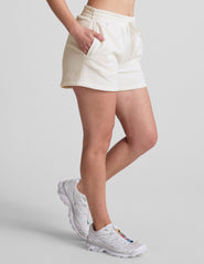 white sweat shorts with pockets and a drawstring at waistband.