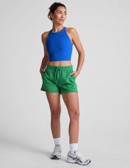 green sweat shorts with pockets and a drawstring at waistband.