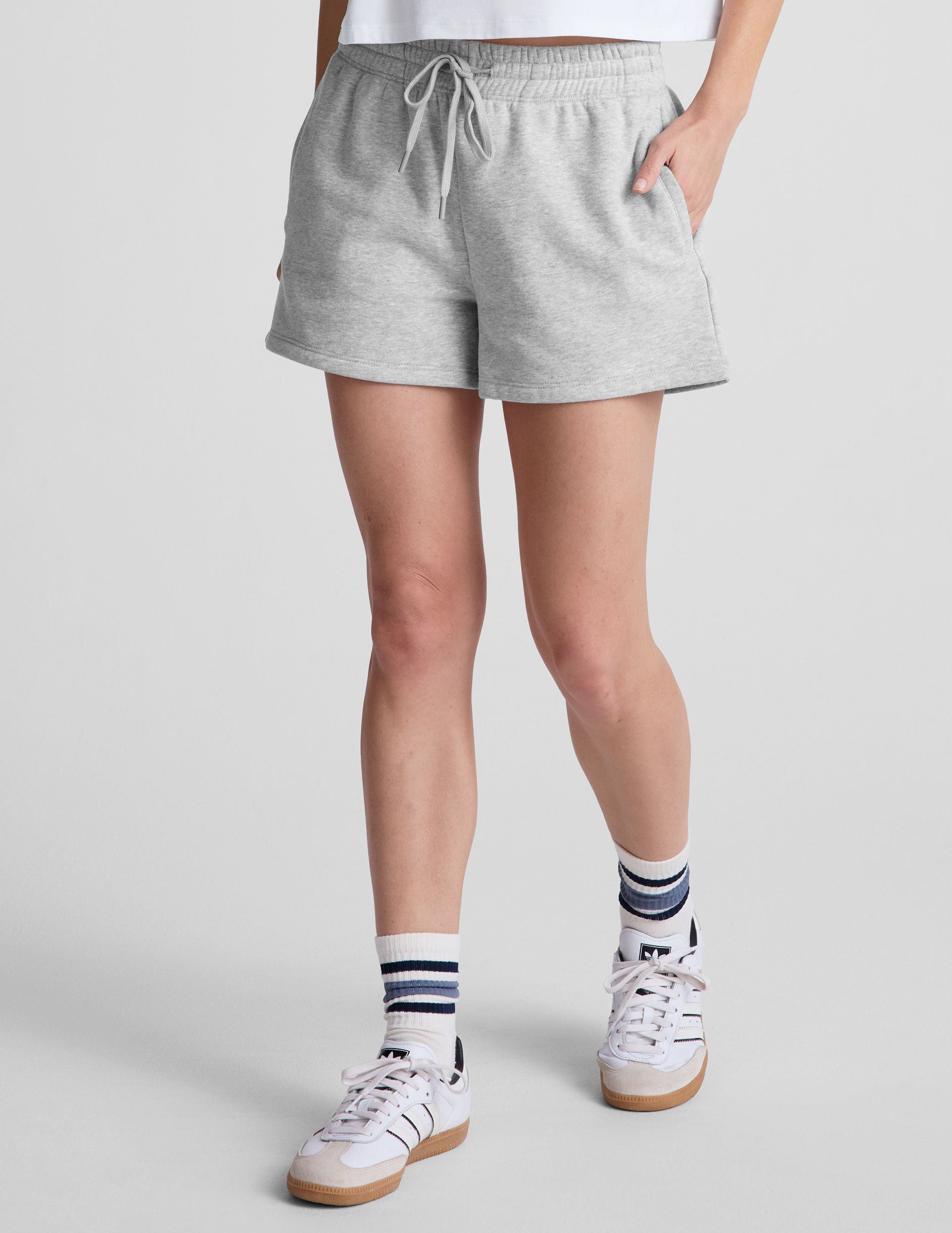 gray sweat shorts with pockets and a drawstring at waistband.