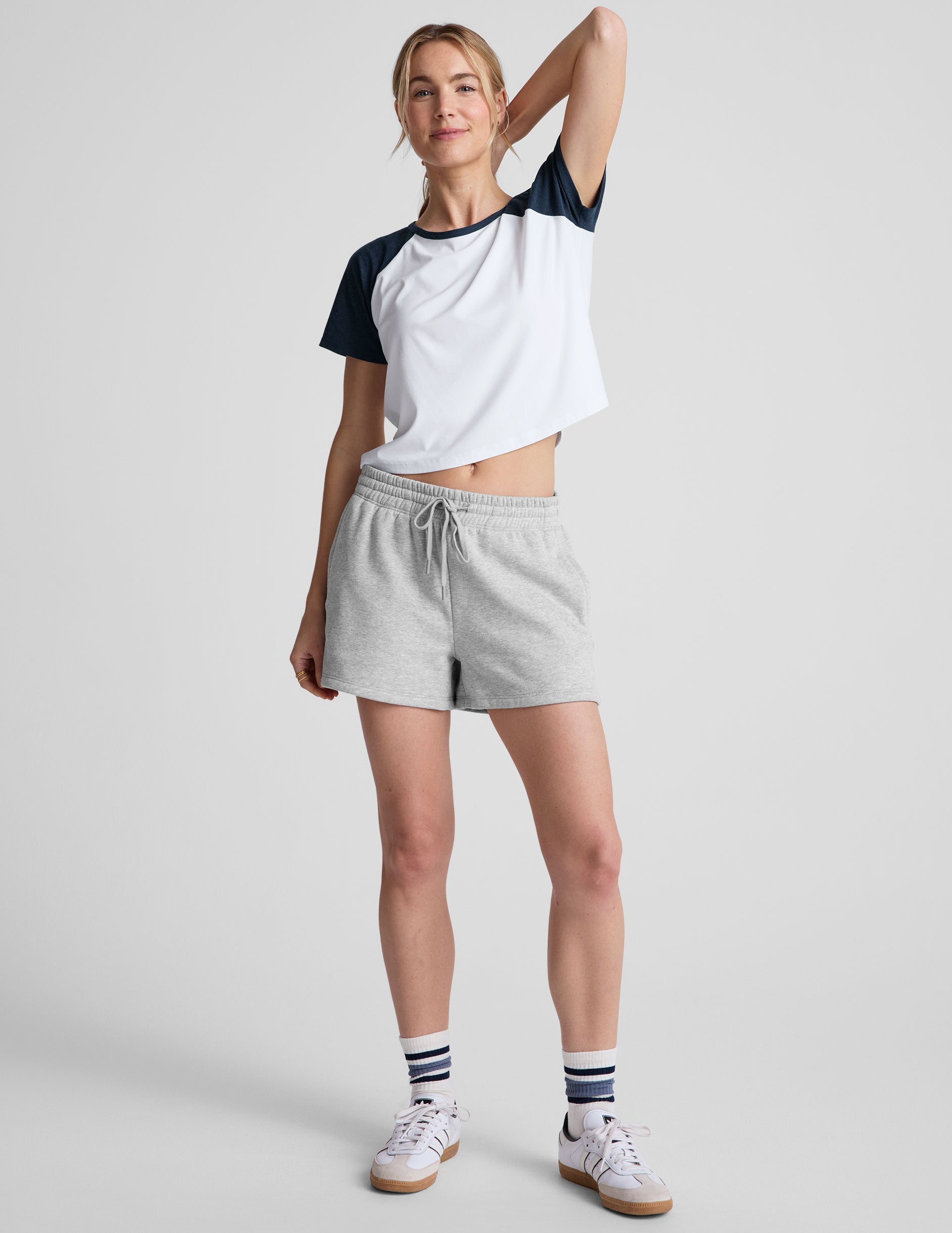 gray sweat shorts with pockets and a drawstring at waistband.