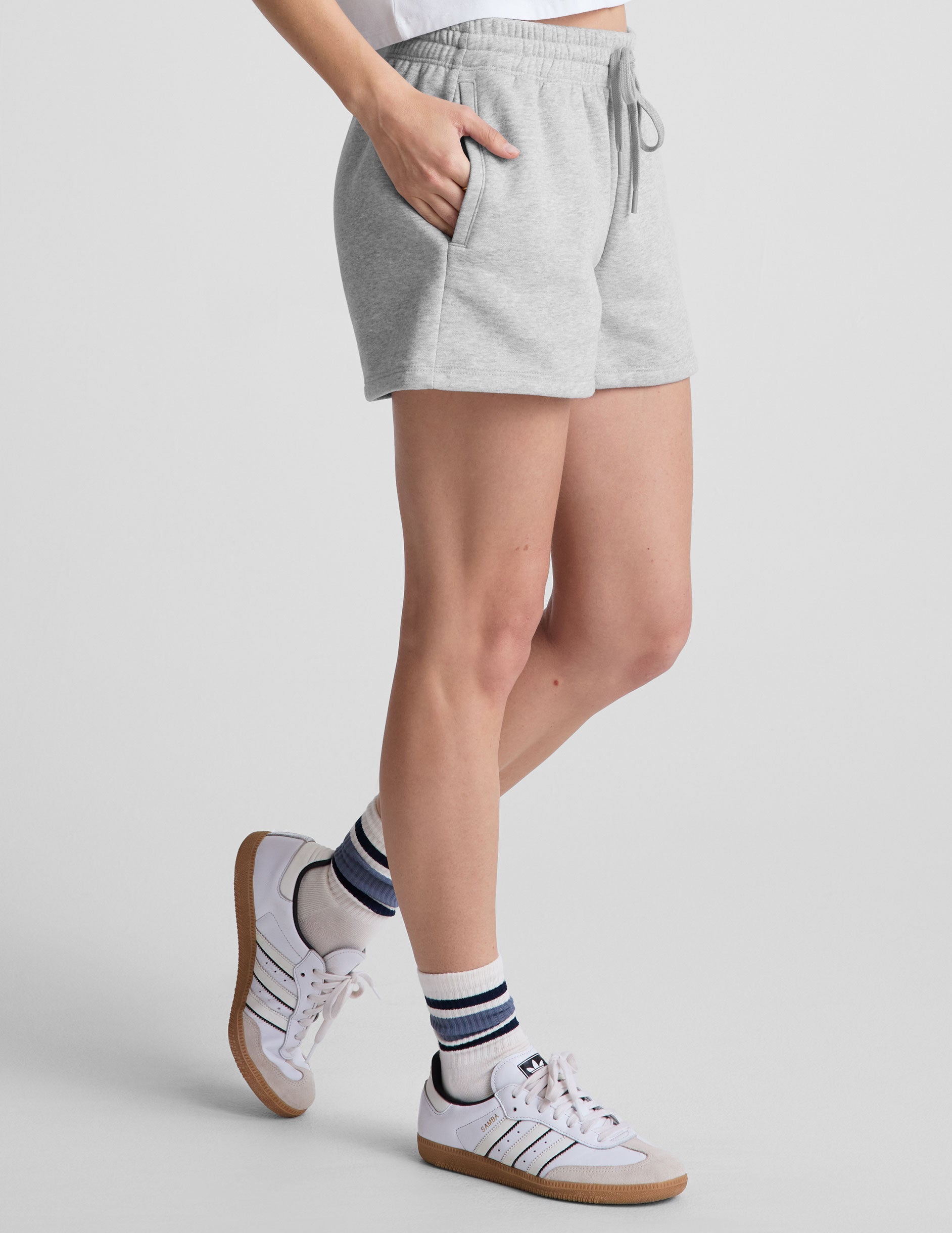 gray sweat shorts with pockets and a drawstring at waistband.