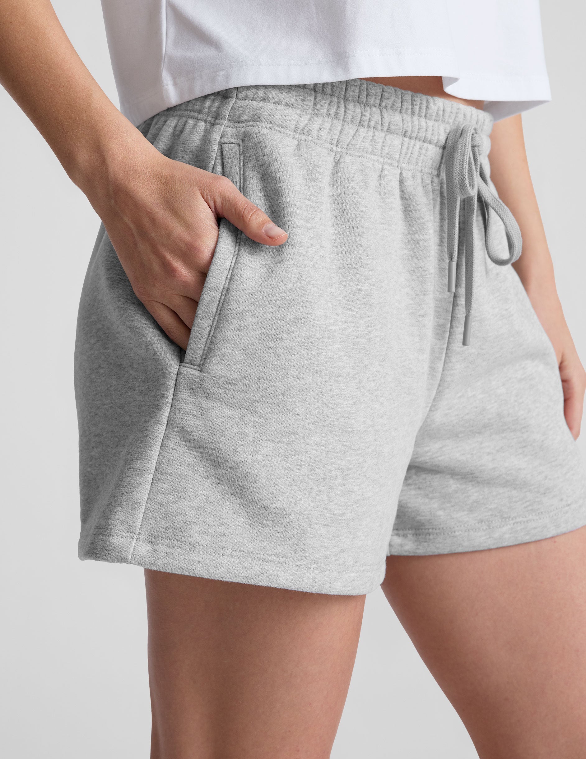 gray sweat shorts with pockets and a drawstring at waistband.