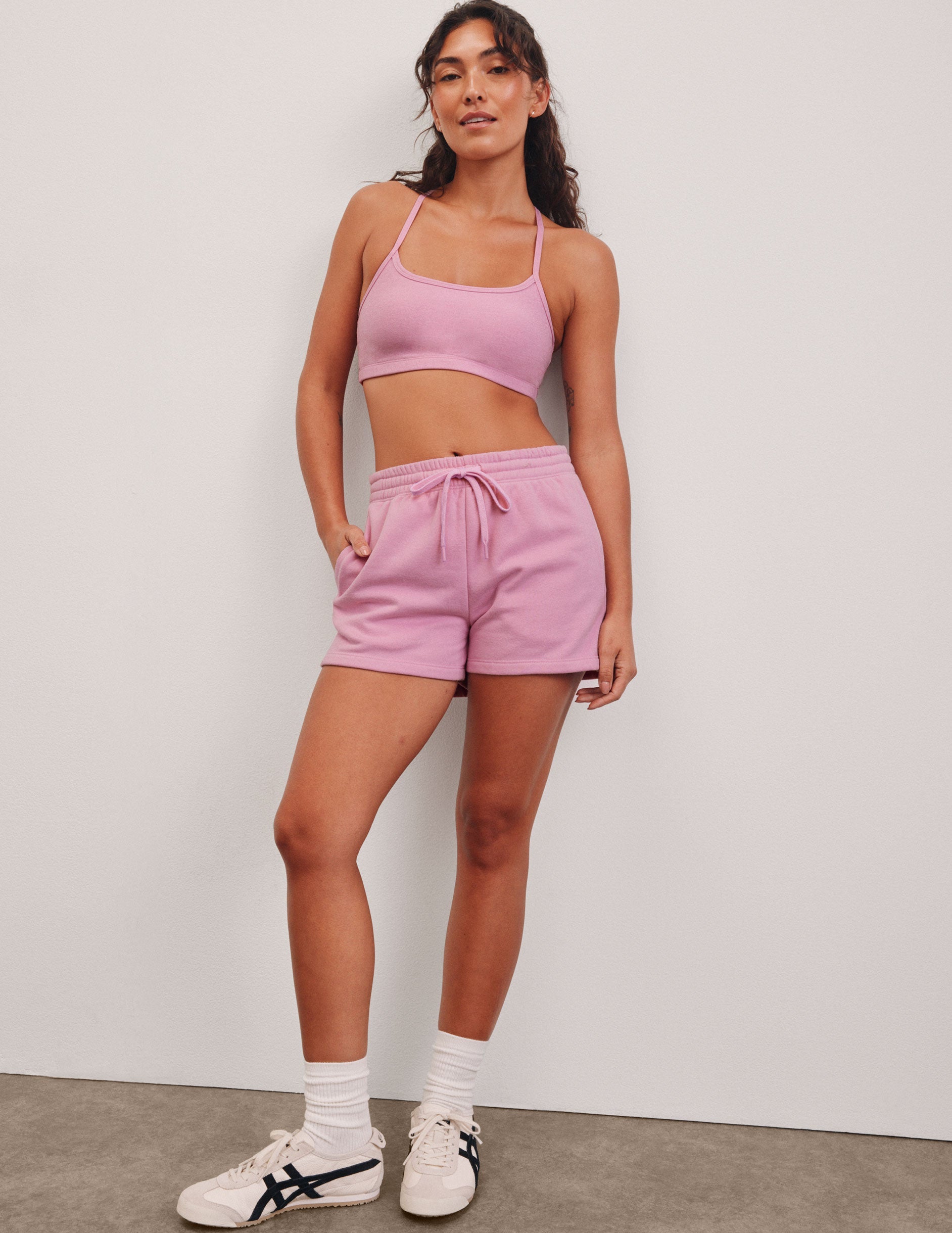 pink sweat shorts with pockets and a drawstring at waistband.