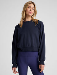 blue loose-fitting classic length crew neck sweatshirt.