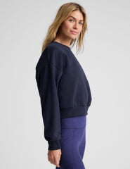 blue loose-fitting classic length crew neck sweatshirt.
