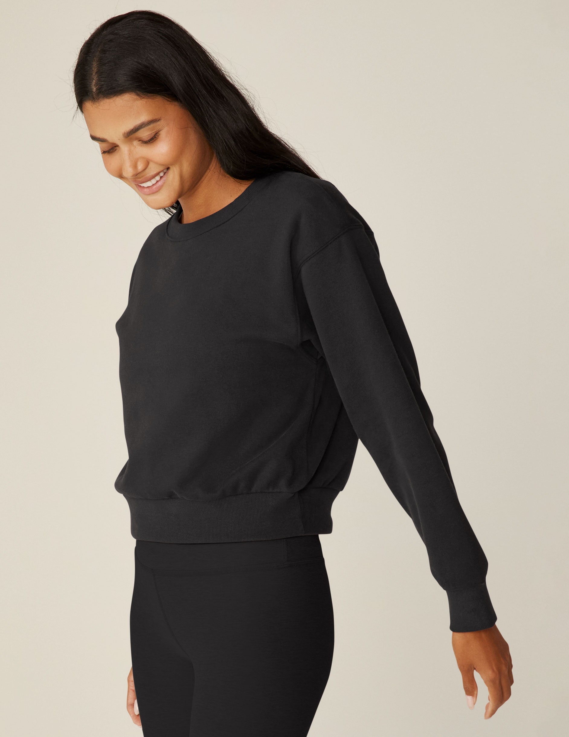 black loose-fitting classic length crew neck sweatshirt.