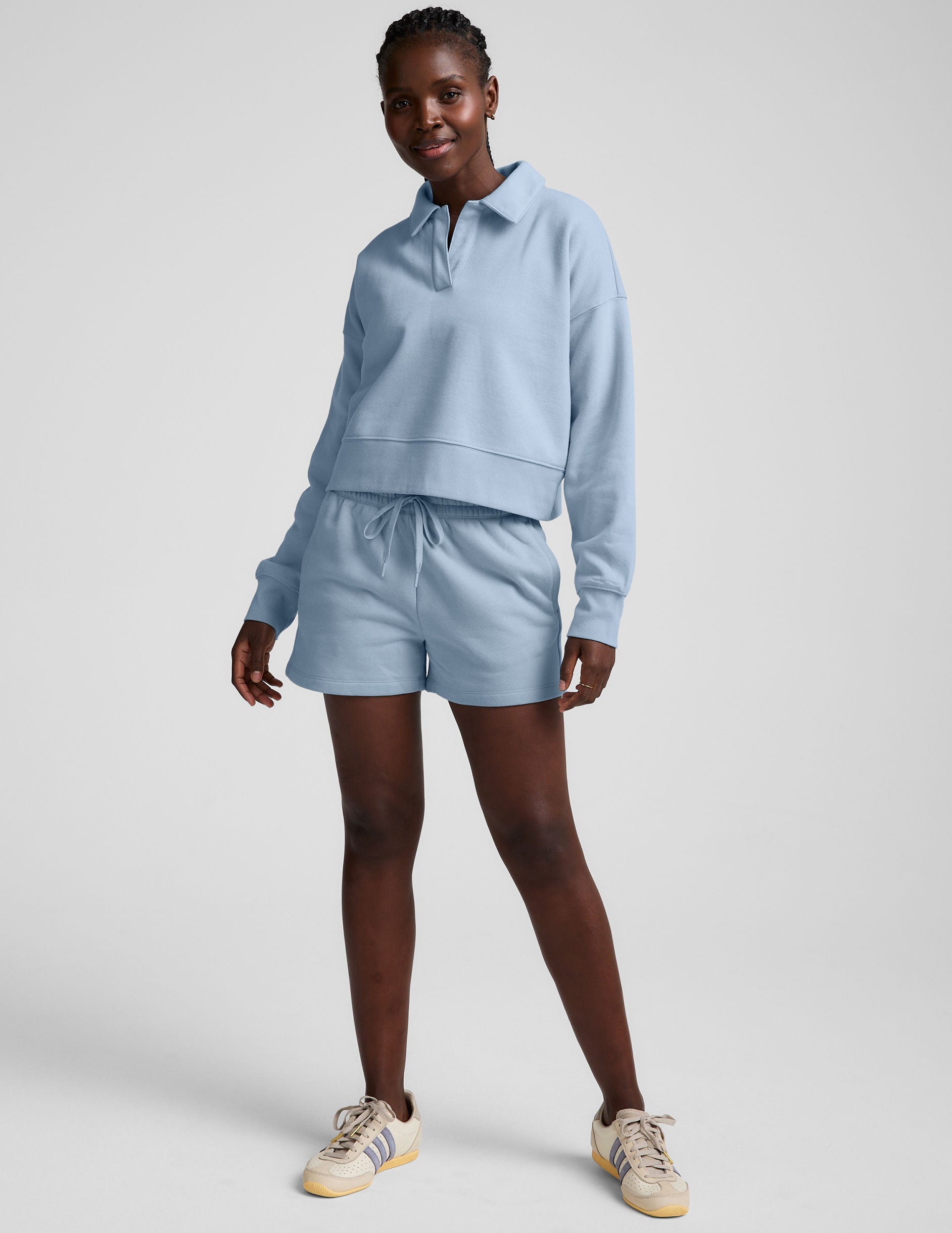 blue cropped long sleeve pullover with a v-neck collared neckline.
