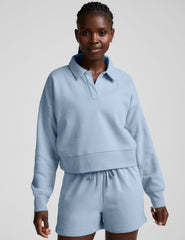blue cropped long sleeve pullover with a v-neck collared neckline.