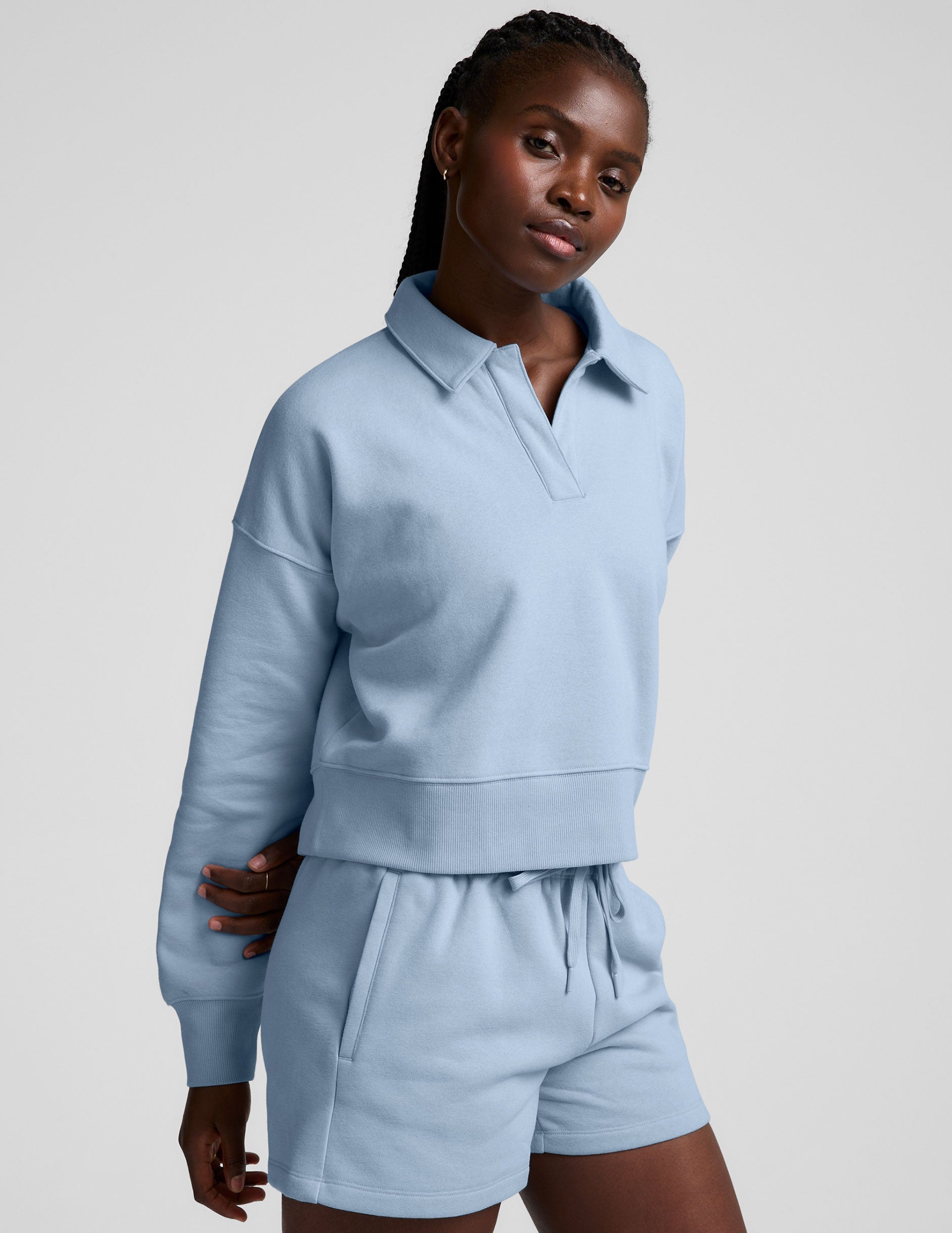blue cropped long sleeve pullover with a v-neck collared neckline.