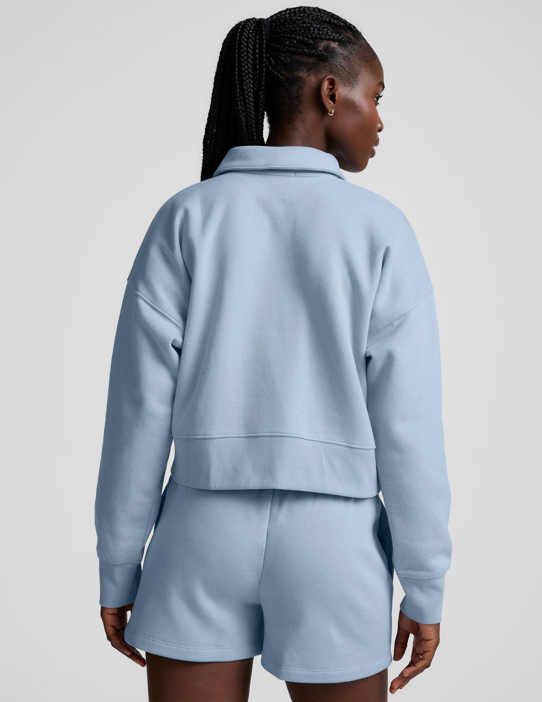 blue cropped long sleeve pullover with a v-neck collared neckline.