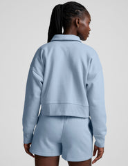 blue cropped long sleeve pullover with a v-neck collared neckline.