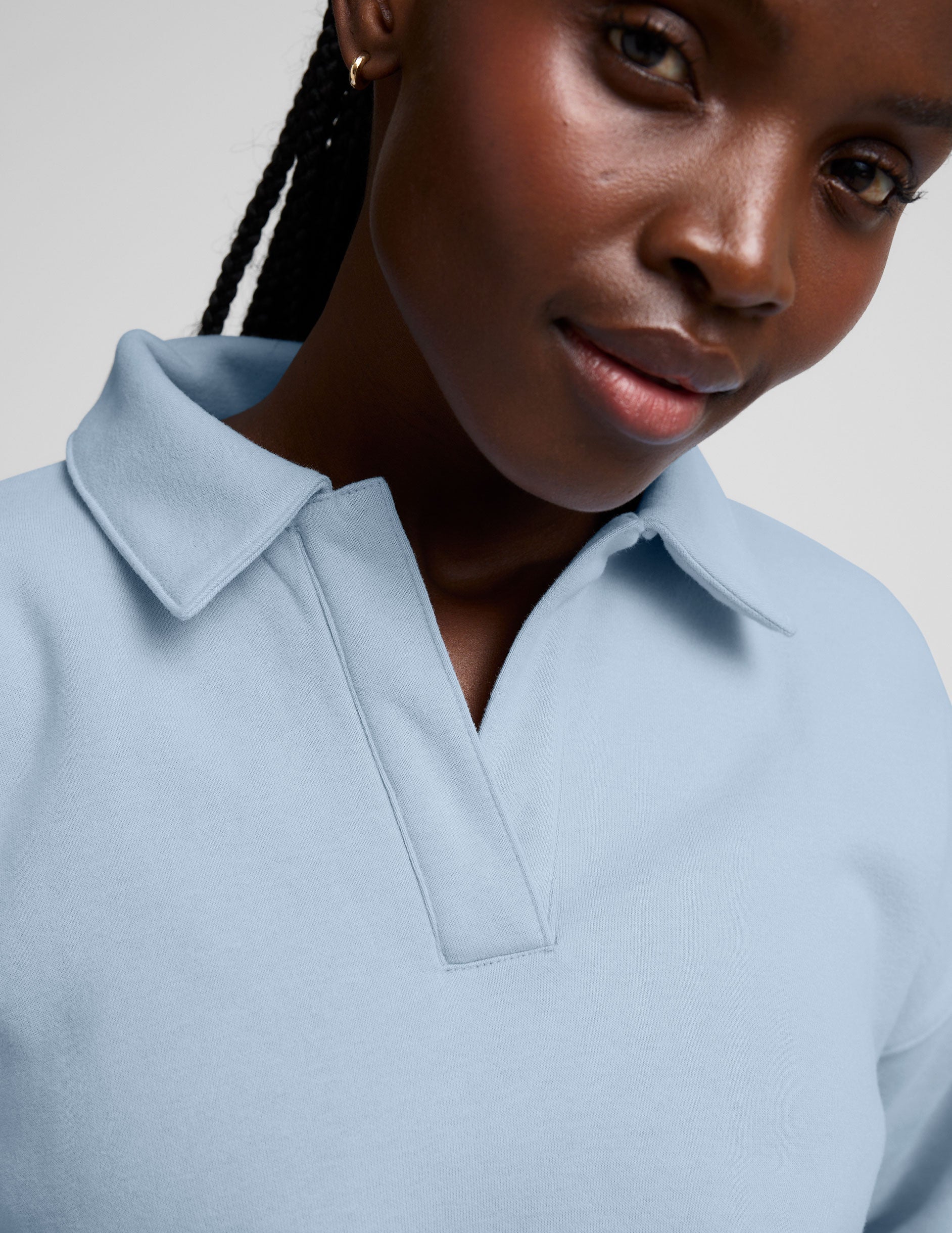 blue cropped long sleeve pullover with a v-neck collared neckline.
