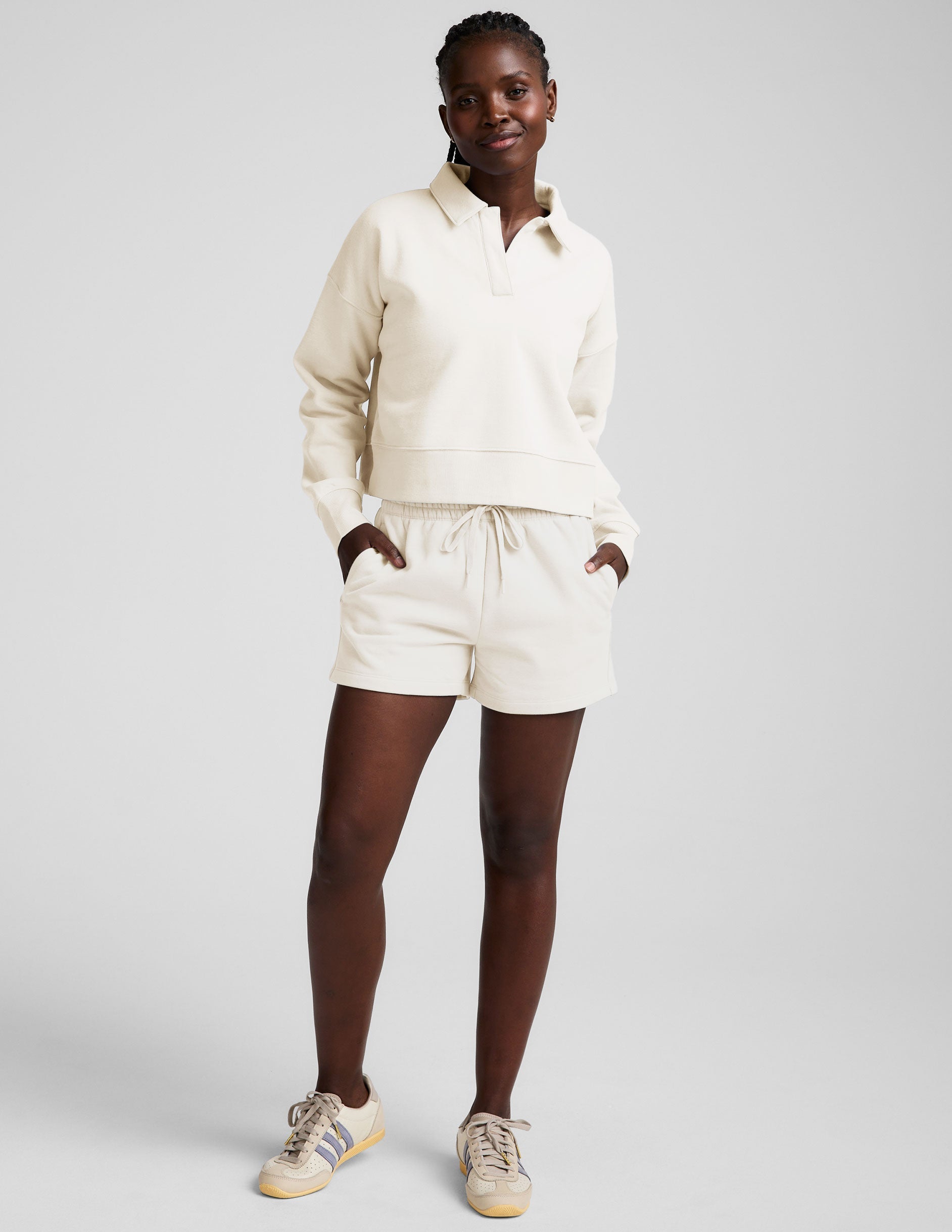 white cropped fleece sweatshirt with a collar and v-neck.