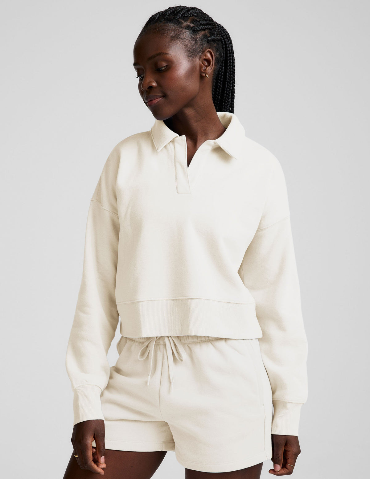 white cropped fleece sweatshirt with a collar and v-neck.