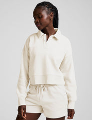 white cropped fleece sweatshirt with a collar and v-neck.