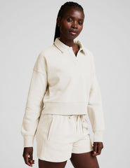white cropped fleece sweatshirt with a collar and v-neck.