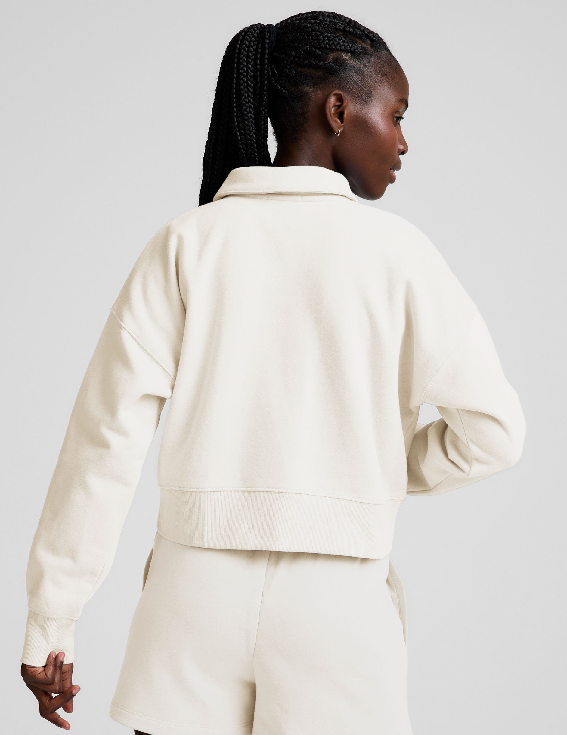 white cropped fleece sweatshirt with a collar and v-neck.