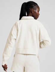 white cropped fleece sweatshirt with a collar and v-neck.