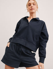 blue cropped long sleeve pullover with a v-neck collared neckline.