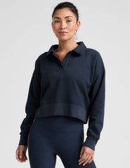 blue cropped long sleeve pullover with a v-neck collared neckline.