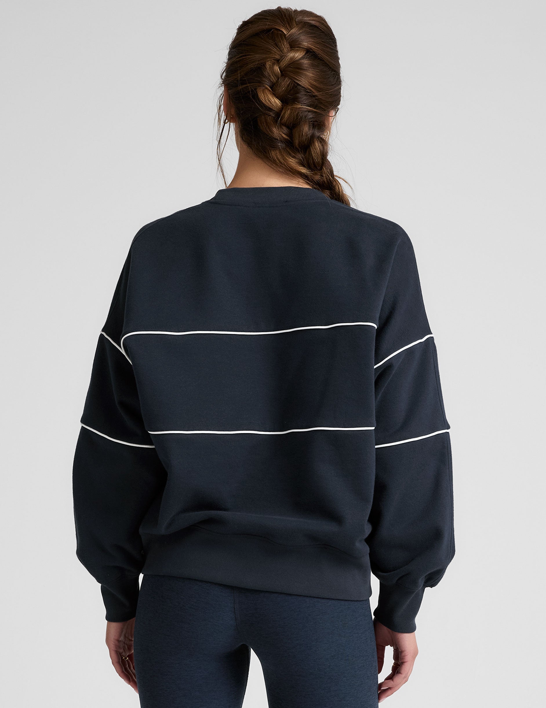 blue fleece crewneck sweater with white contrast piping trim at chest and sleeves.