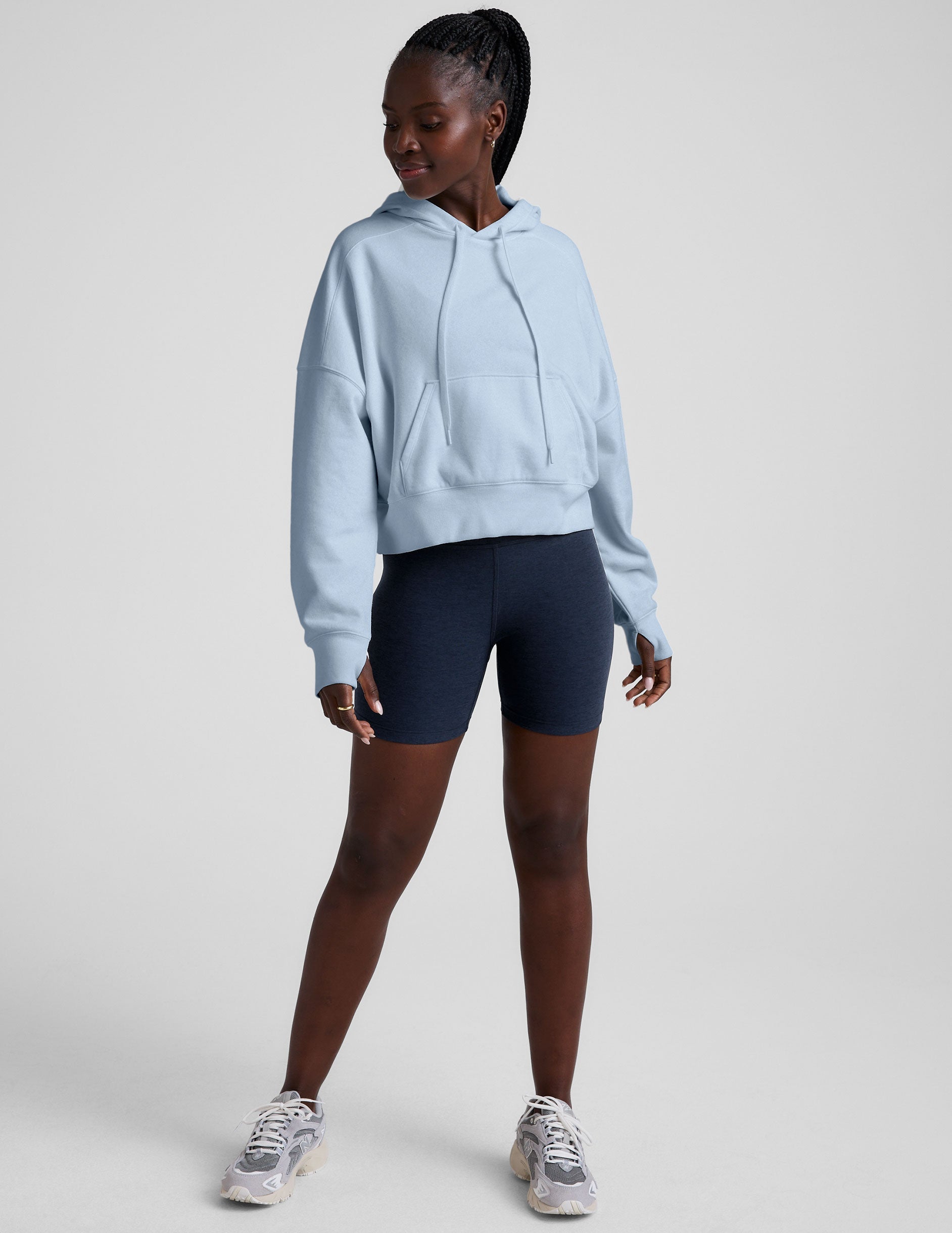 blue cropped pullover with a hood with drawcord and a kangaroo pocket.