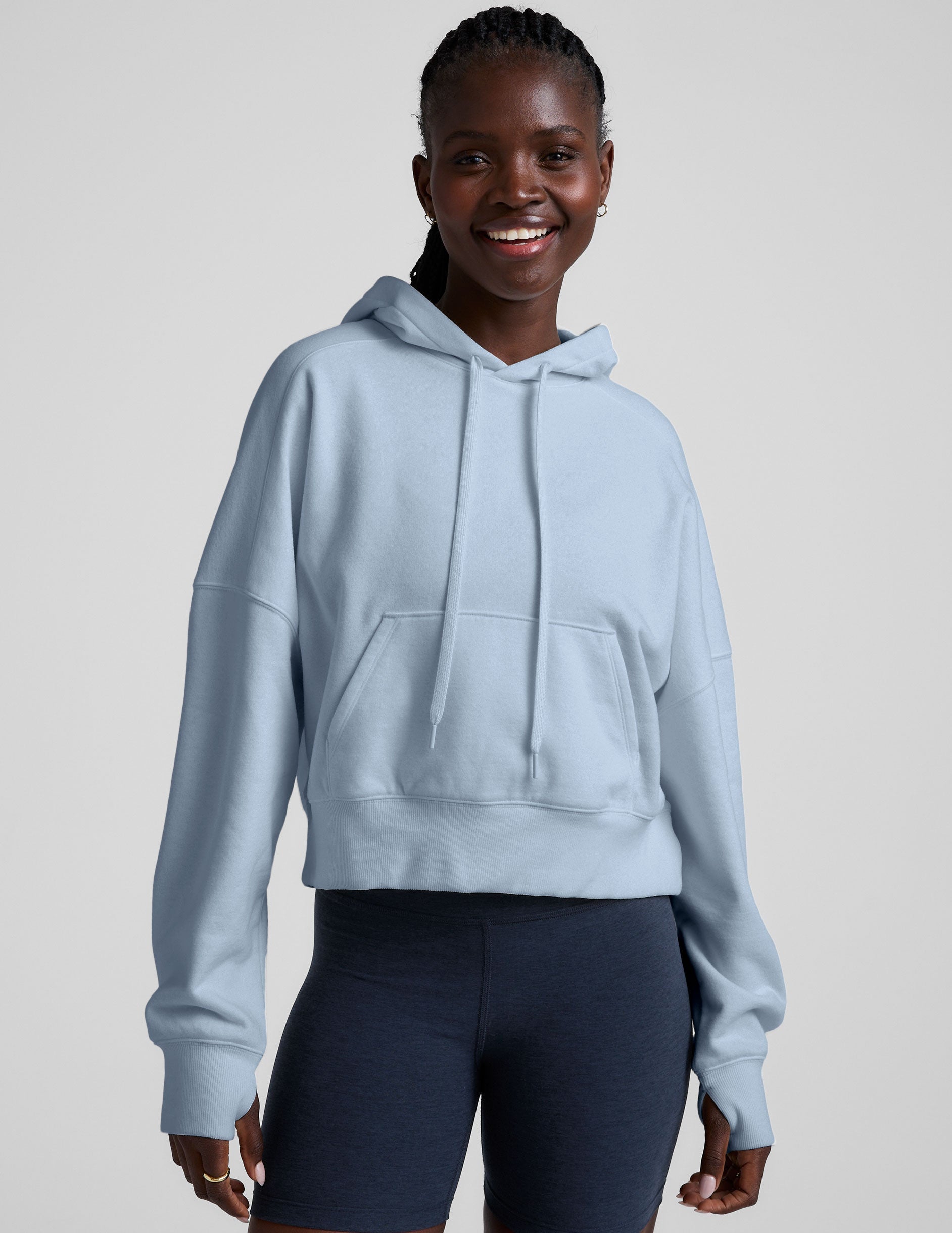 blue cropped pullover with a hood with drawcord and a kangaroo pocket.