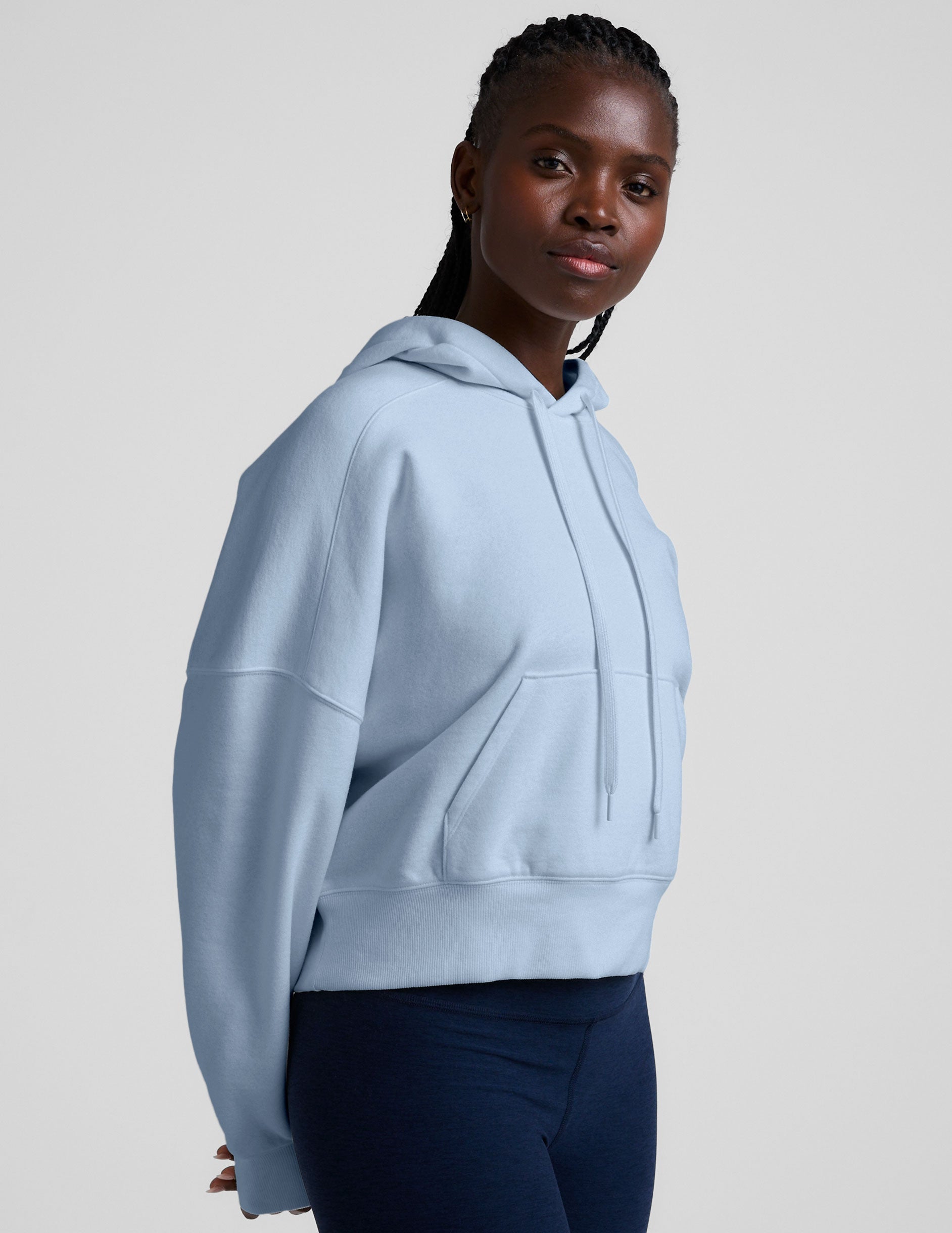 blue cropped pullover with a hood with drawcord and a kangaroo pocket.