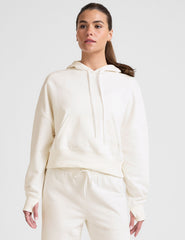 white cropped pullover with a hood with drawcord and a kangaroo pocket.