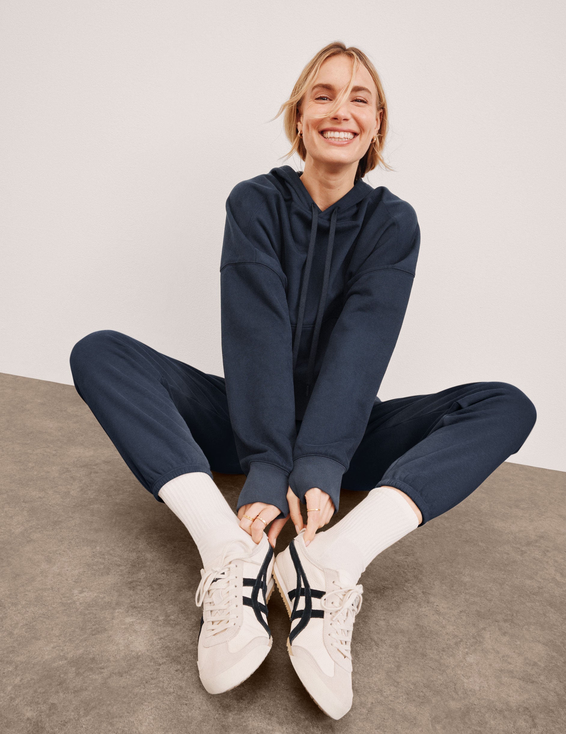 blue cropped pullover with a hood with drawcord and a kangaroo pocket.