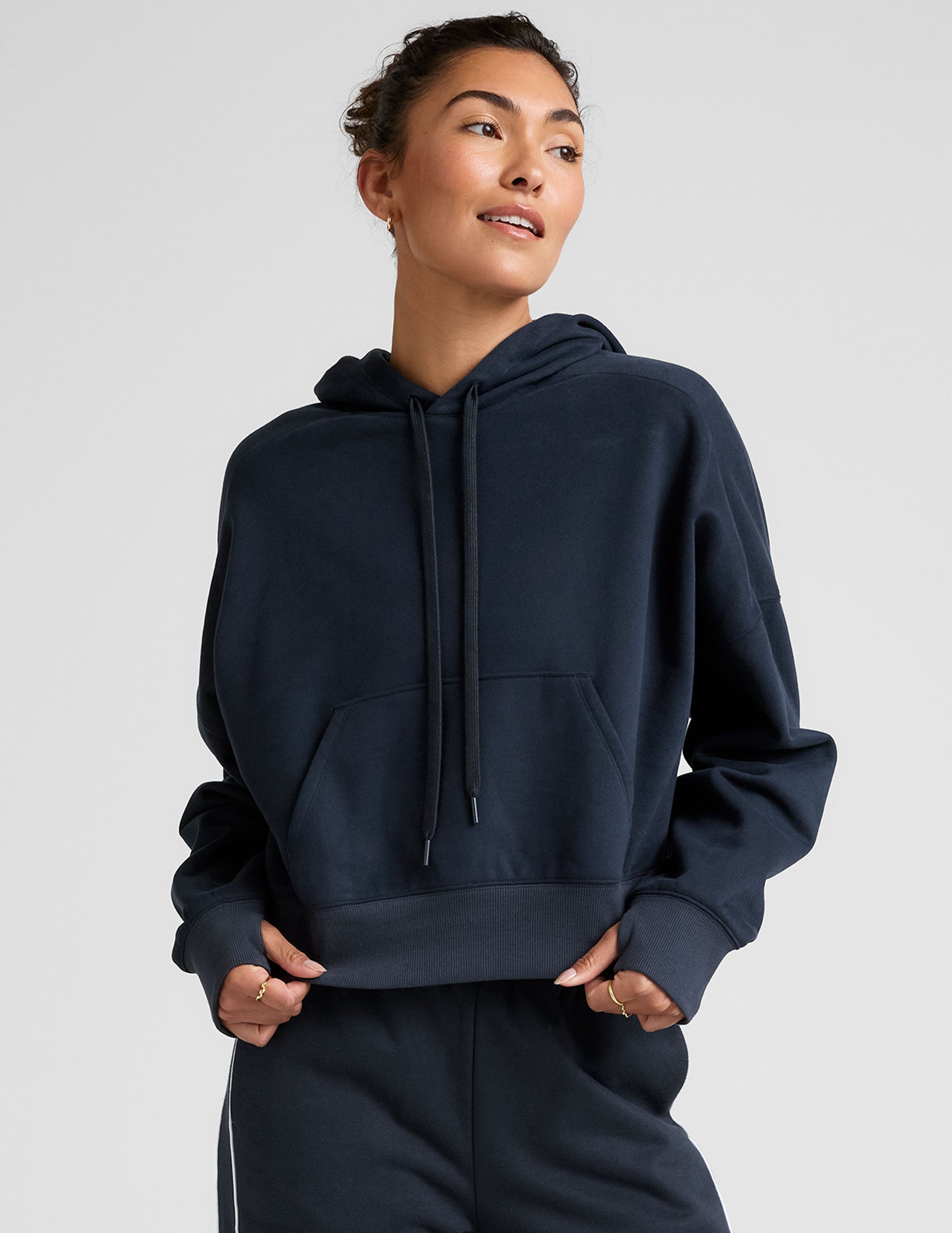 blue cropped pullover with a hood with drawcord and a kangaroo pocket.